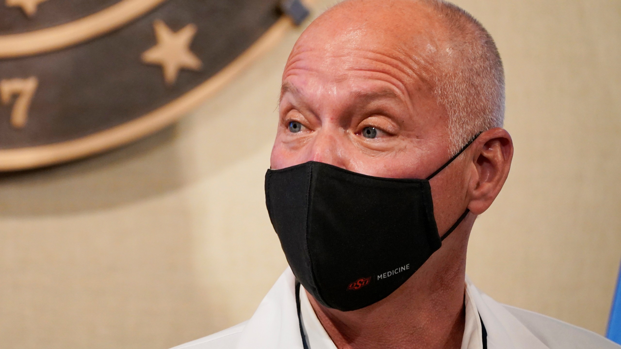 In this Monday, Nov. 16, 2020, photo, interim Oklahoma Health Commissioner Dr. Lance Frye speaks during a news conference in Oklahoma City. Concerning the coronavirus surge in Oklahoma, Frye said in a statement "We must remember that each count, each case and each infection is a life." Frye again urged residents to wear masks, frequently wash their hands and stay away from others. (AP Photo/Sue Ogrocki)