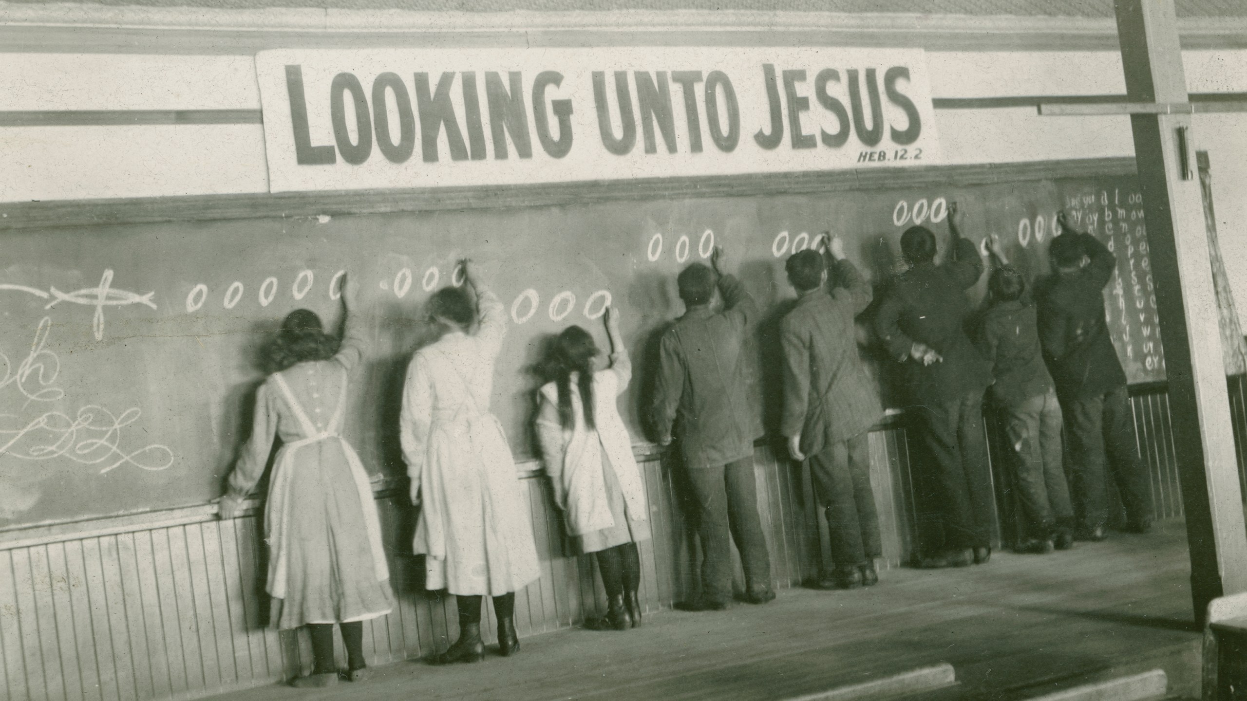 In this 1910s photo provided by the United Church of Canada Archives, students write on a chalkboard at the Red Deer Indian Industrial School in Alberta.