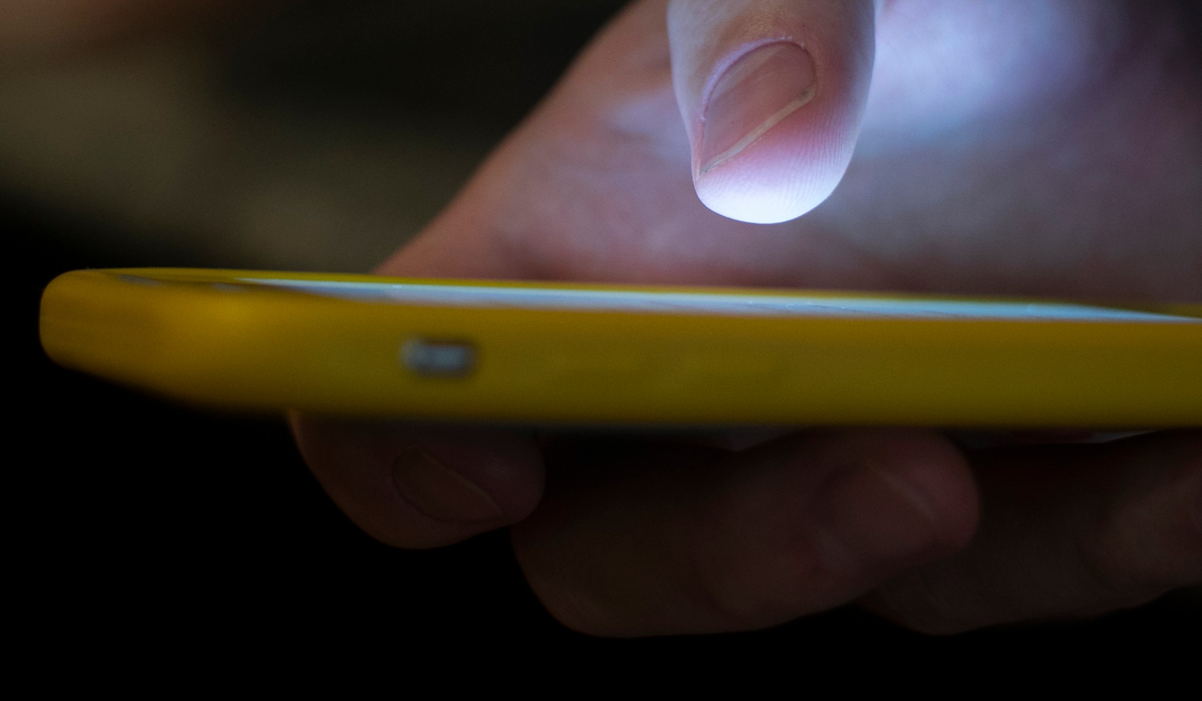 FILE - In this Aug. 11, 2019, file photo, a man uses a cellphone in New Orleans. Most Americans don’t believe that their personal information is secure online and aren't satisfied with the federal government's efforts to protect it, according to a new poll by The Associated Press-NORC Center for Public Affairs Research and MeriTalk. (AP Photo/Jenny Kane, File)