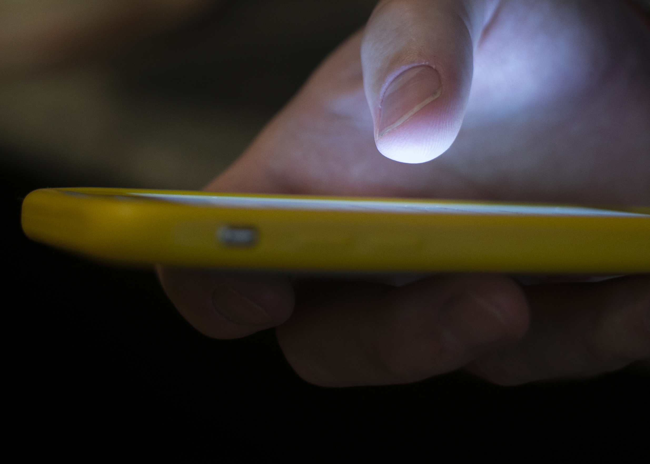 FILE - In this Aug. 11, 2019, file photo, a man uses a cellphone in New Orleans. Most Americans don’t believe that their personal information is secure online and aren't satisfied with the federal government's efforts to protect it, according to a new poll by The Associated Press-NORC Center for Public Affairs Research and MeriTalk. (AP Photo/Jenny Kane, File)