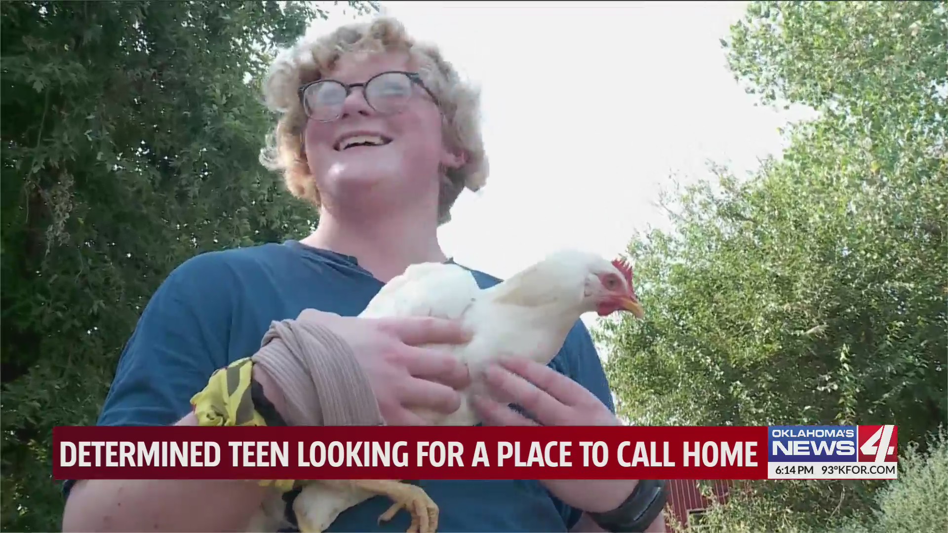 Dax smiles while holding a chicken