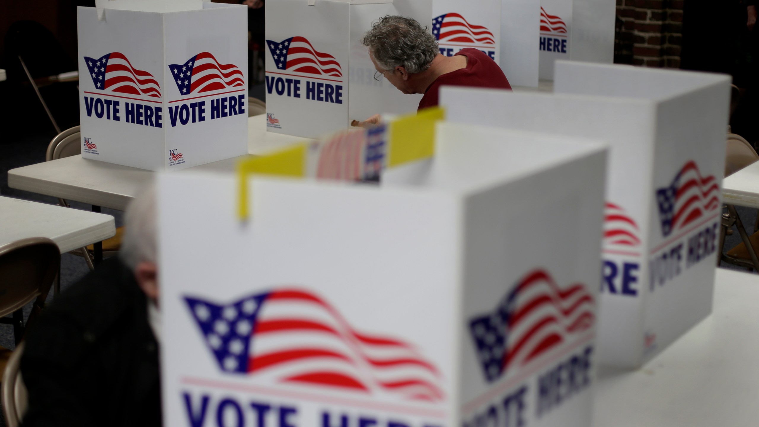 FILE - In this March 10, 2020, file photo, a man votes in the presidential primary election at the the Summit View Church of the Nazarene in Kansas City, Mo. A federal appeals court ruled Wednesday, April 29, 2020, that proof of citizenship requirement for Kansas voter registration is unconstitutional. (AP Photo/Charlie Riedel, File)