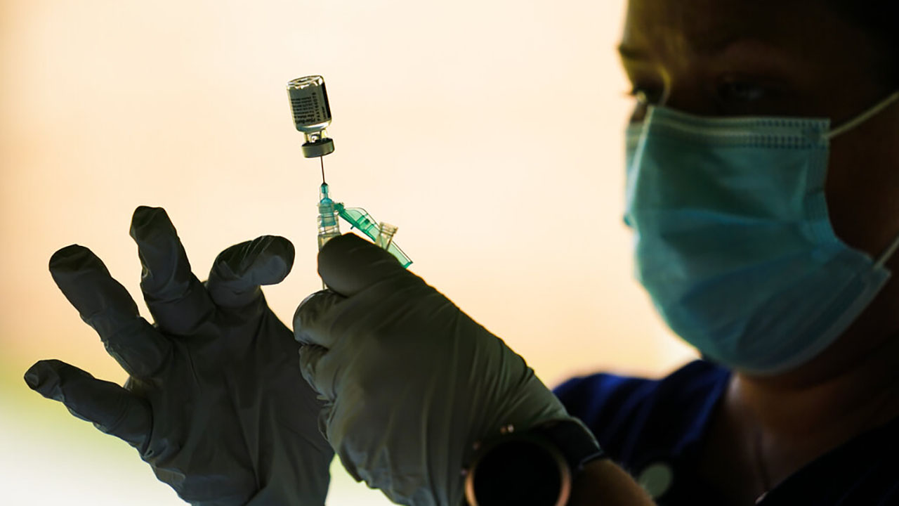 In this Sept. 14, 2021, file photo, a syringe is prepared with the Pfizer COVID-19 vaccine at a clinic at the Reading Area Community College in Reading, Pa.