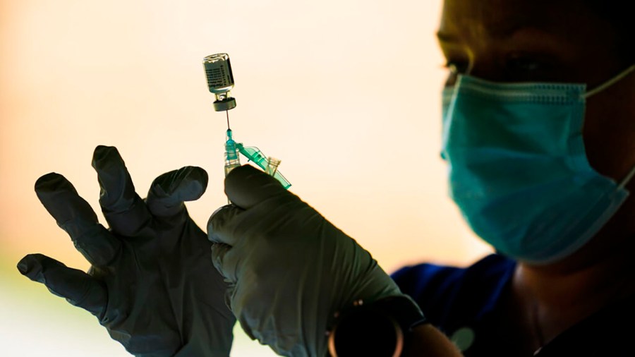 In this Sept. 14, 2021, file photo, a syringe is prepared with the Pfizer COVID-19 vaccine at a clinic at the Reading Area Community College in Reading, Pa.